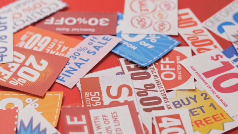 A bunch of coupons on a white surface.