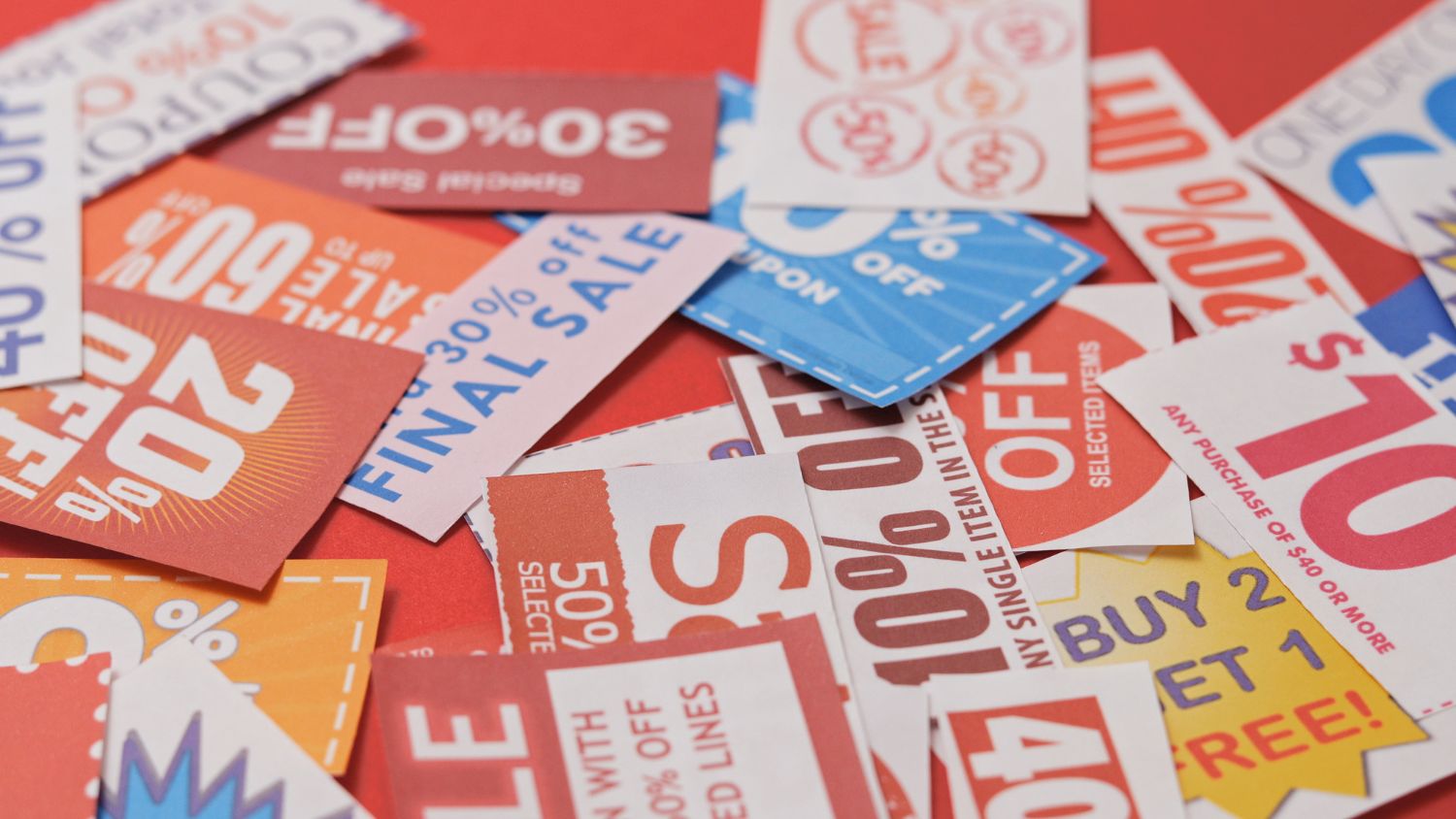 A bunch of coupons on a white surface.