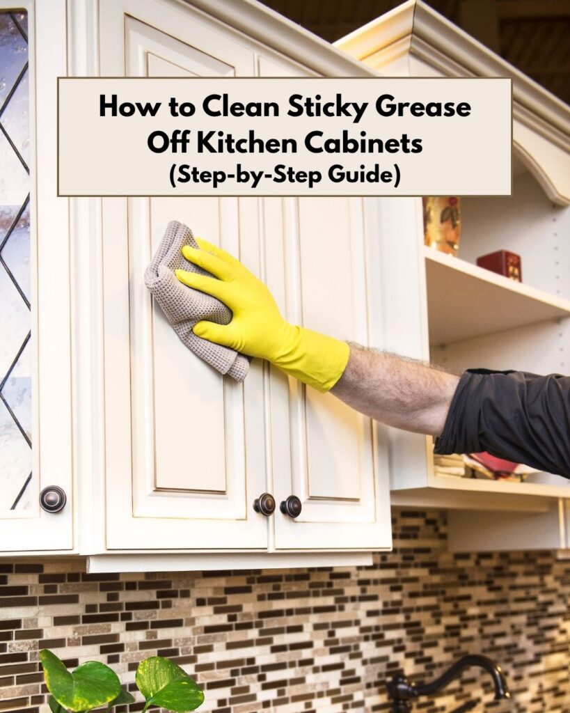 A person wiping a white kitchen overhead cabinet.