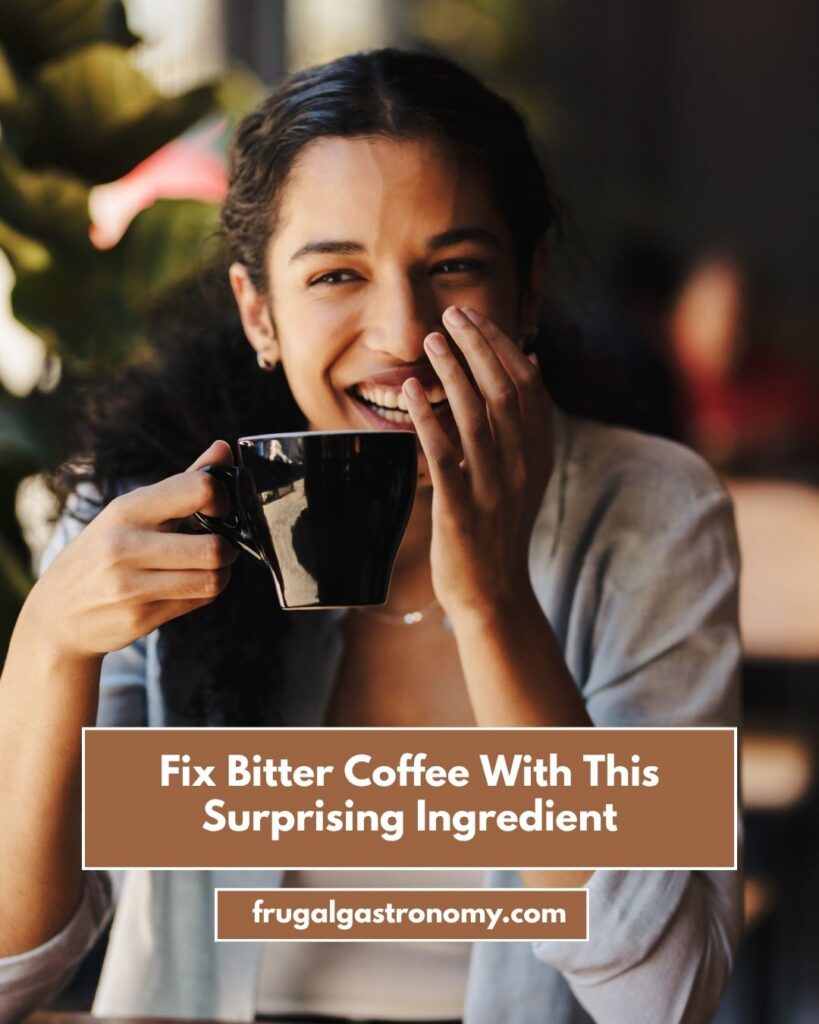 A woman drinking coffee while smiling.