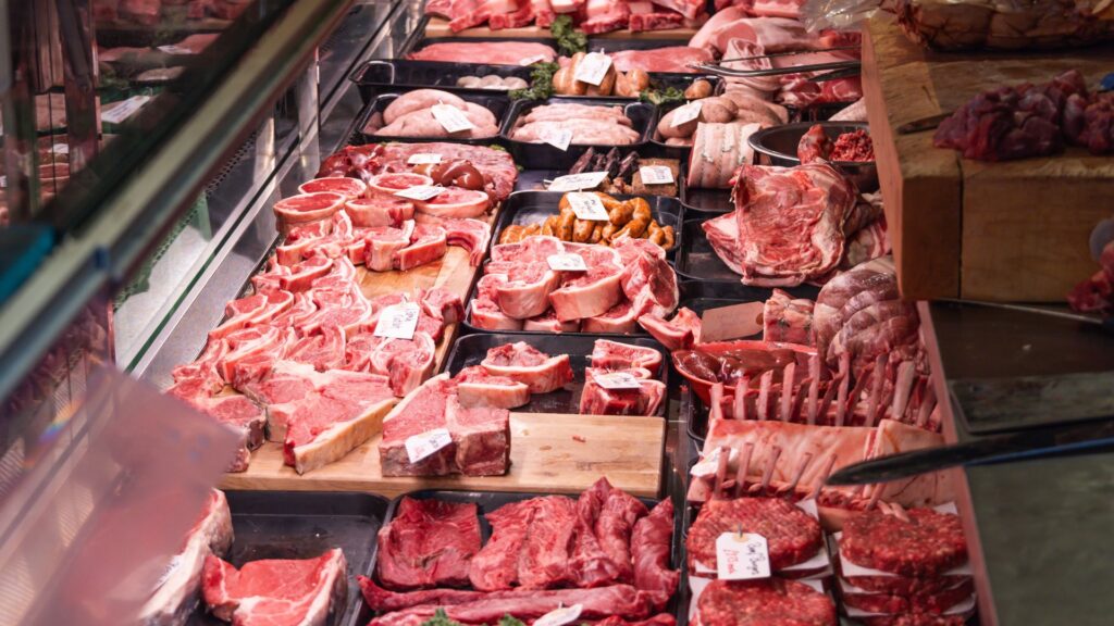 A wide variety of meats in different cuts on display in a butchery. The cut is a big factor on how long raw steak lasts in the fridge.
