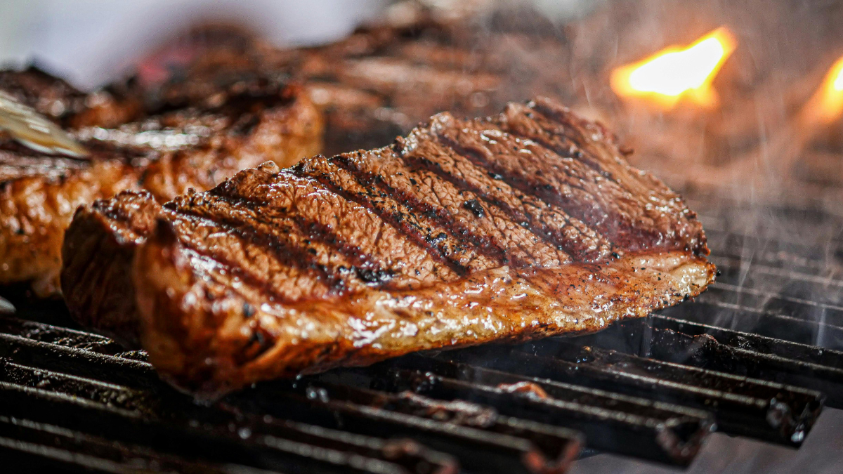 Closeup shot of steaks on a grill.