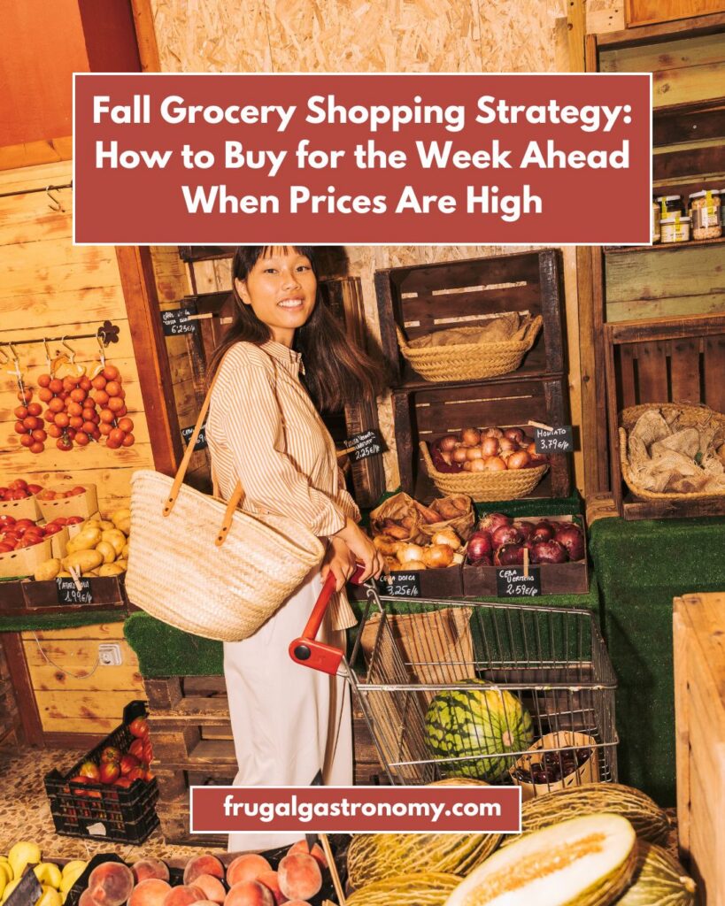 A woman smiling for the camera as she pushes a grocery cart along the fresh produce section.