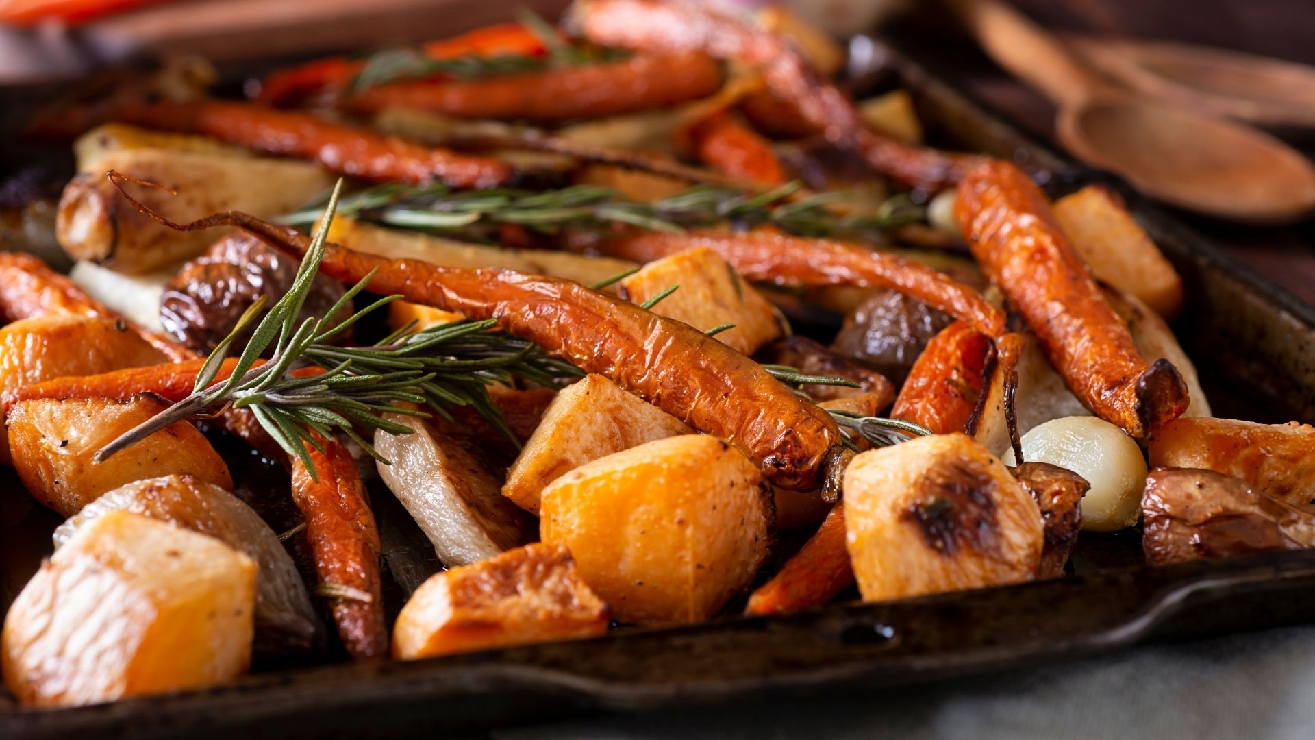 A closeup shot of a sheet tray of roasted root vegetables.