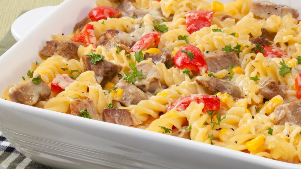 Closeup shot of a casserole with leftover meat, and tossed in cream sauce.