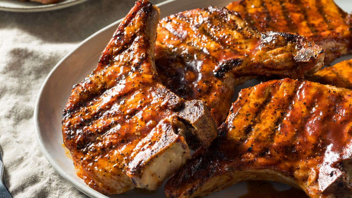 A plate of girlled pork chops. This article talks about The Cheapest Cuts of Pork.