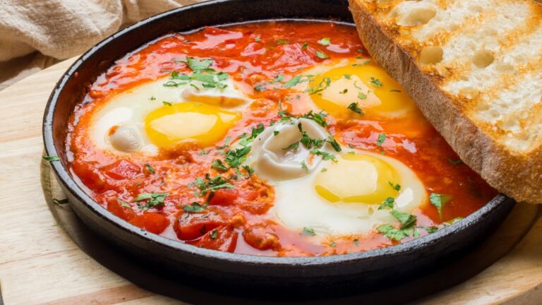 A plate of shakshuka with toasted sourdough on the side. This recipe is one of the reasons why You’ll Love This Weekly Meal Plan for a Family of 4 for $150.
