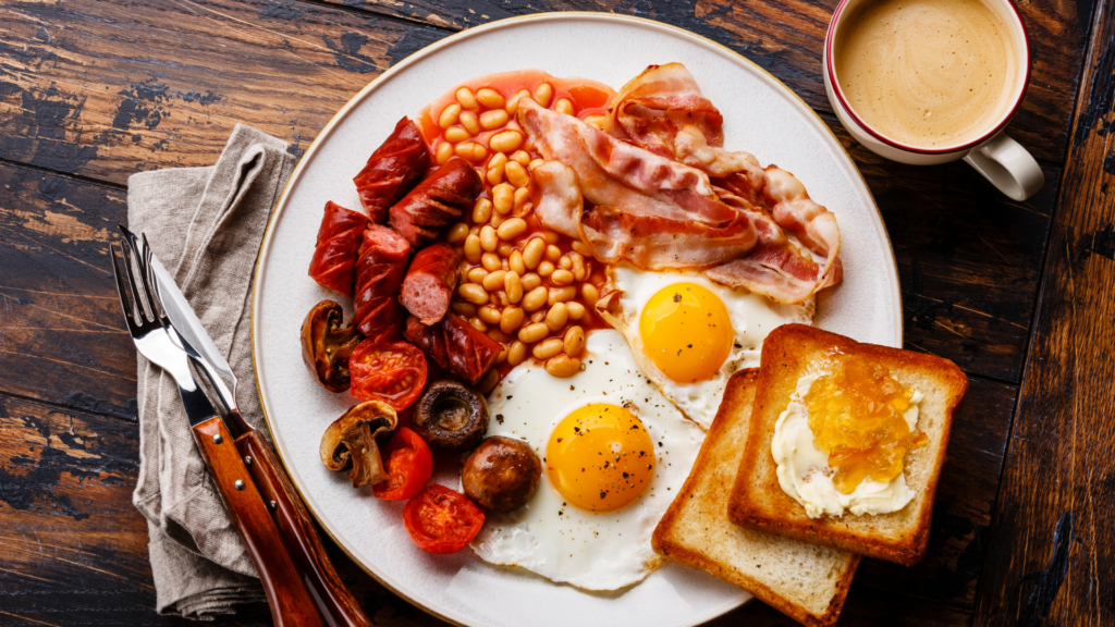 Flat lay shot of a plate of full breakfast with latte on the side.