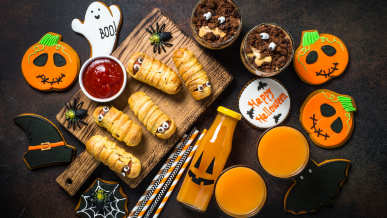 Flat lay shot of Halloween party food on a black background.