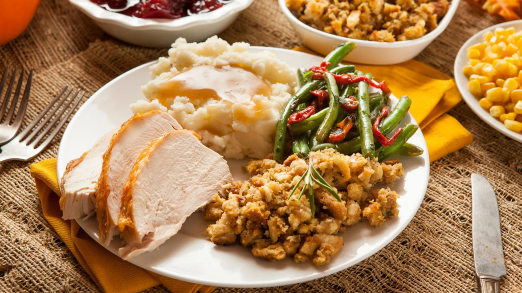 A plate an assortment of Thanksgiving food. There's turkey breasts, stuffing, mashed potatoes and sauteed green beans. This article talks about what to do with Thanksgiving leftovers.