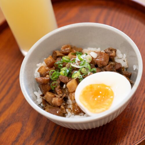 Delicious Taiwanese braised pork rice topped with a soft boiled egg, served in Puli, Taiwan.