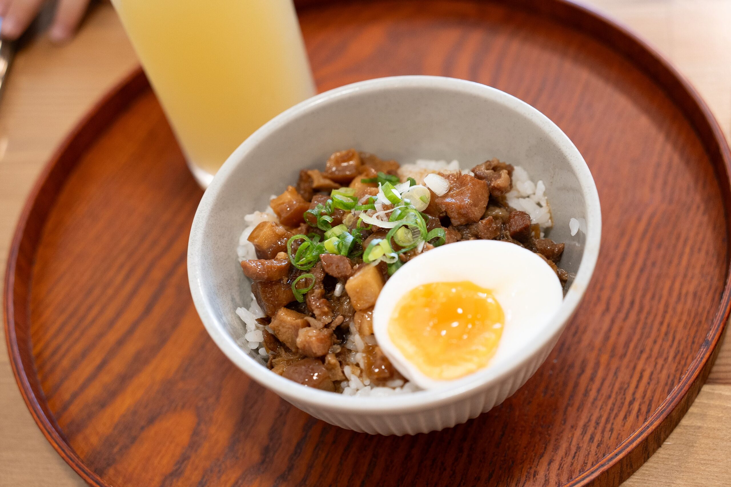 Delicious Taiwanese braised pork rice topped with a soft boiled egg, served in Puli, Taiwan.