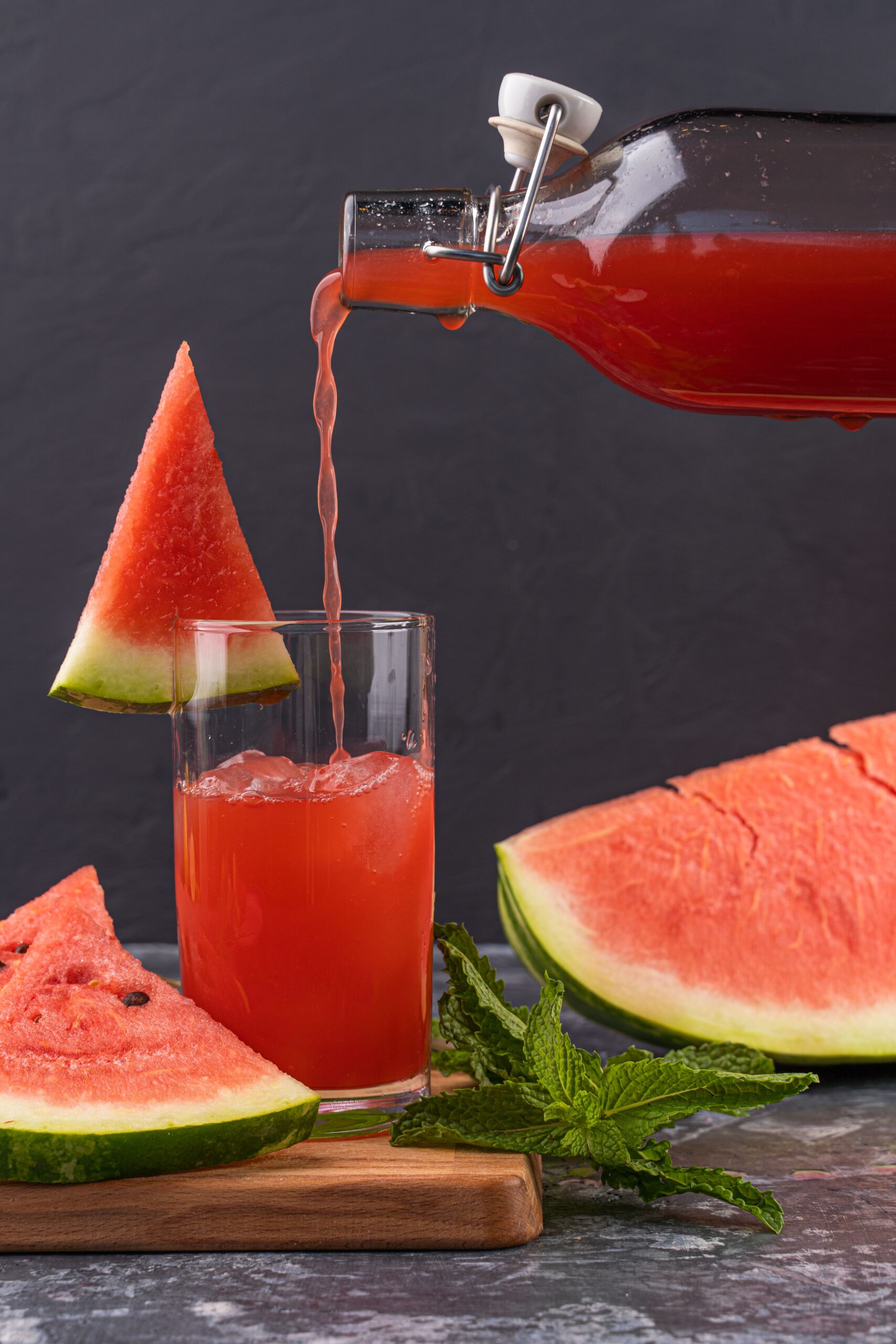 Watermelon punch poured into a glass, garnished with mint and fresh watermelon slices