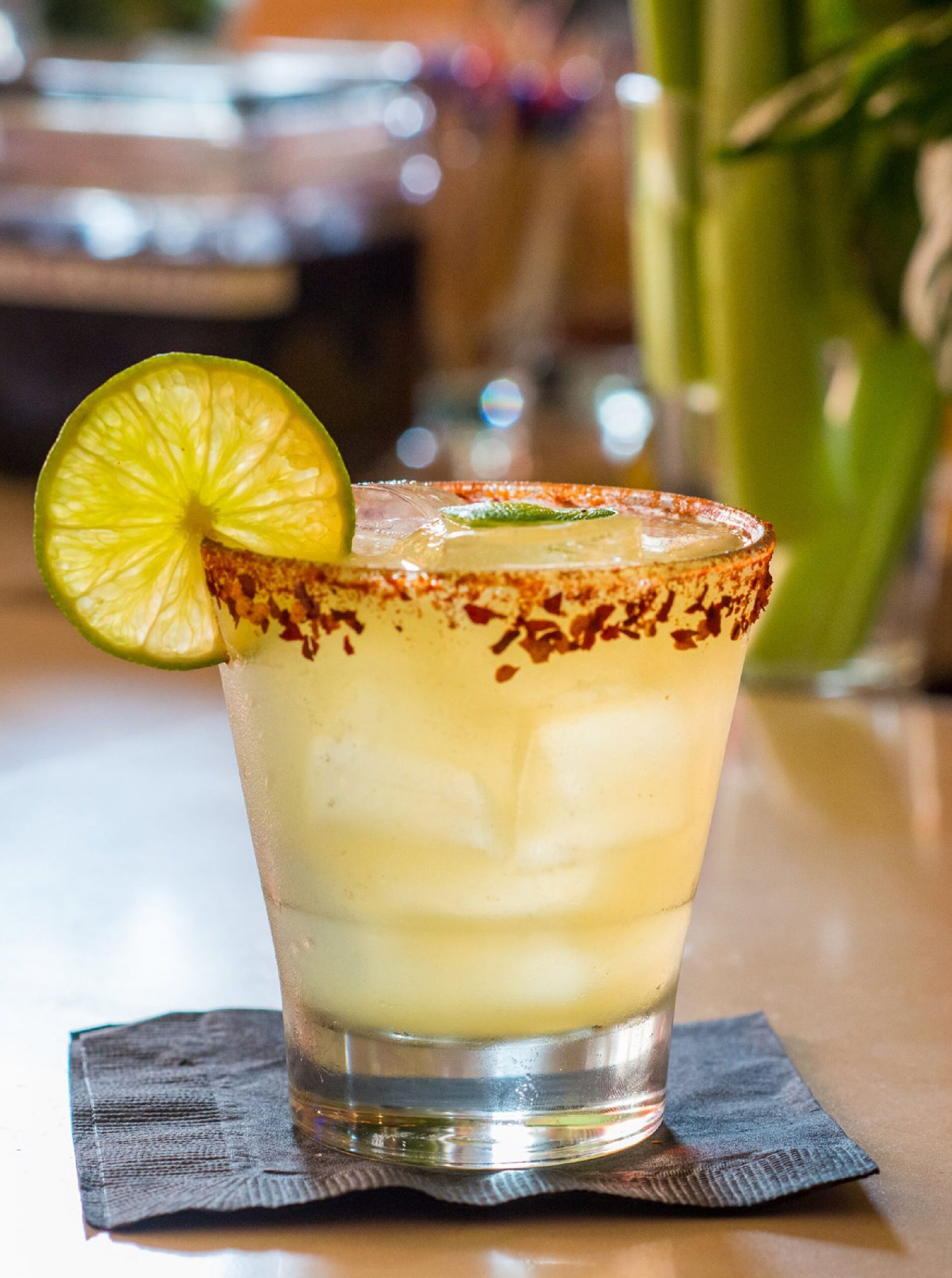 Mango margarita over ice with a chili-lime salt rim and a lime wheel