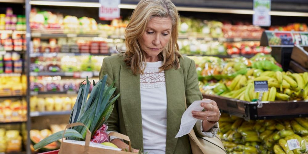 A woman in a grocery store arrange her purchase.