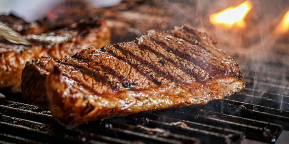 Closeup shot of steaks on a grill.