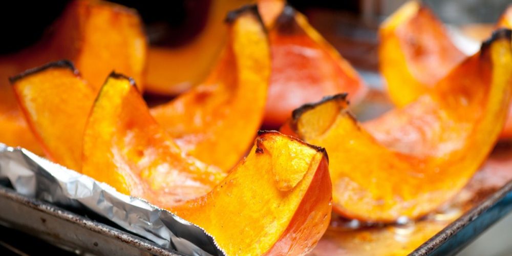 Closeup shot of slices of roasted pumpkins just taken out of the oven. Roasting is one of the many ways on how to use every part of a pumpkin.