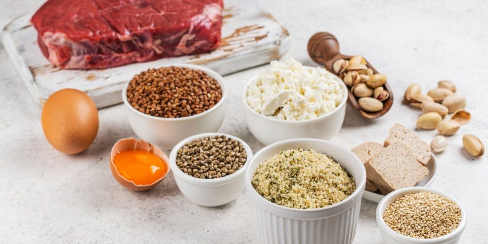 legumes and pulses that are rich protein sources on a marble surface.