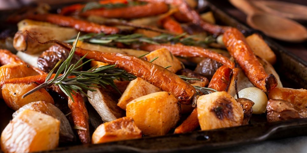 A closeup shot of a sheet tray of roasted root vegetables.