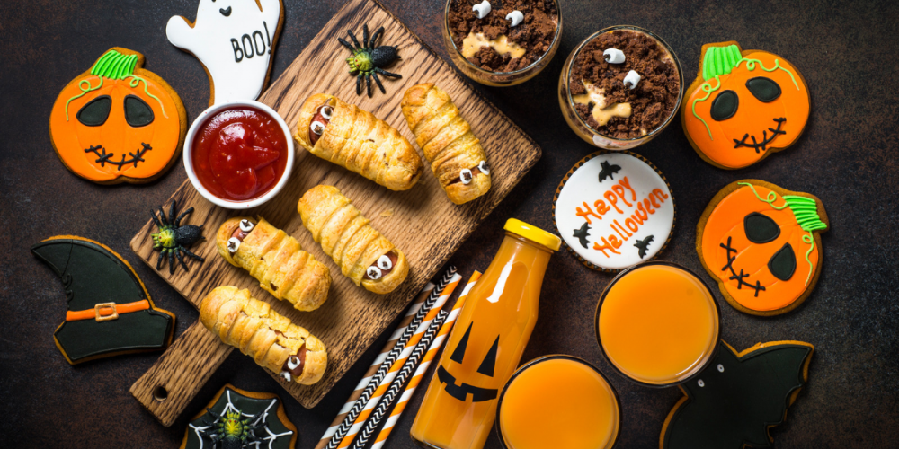 Flat lay shot of Halloween party food on a black background.