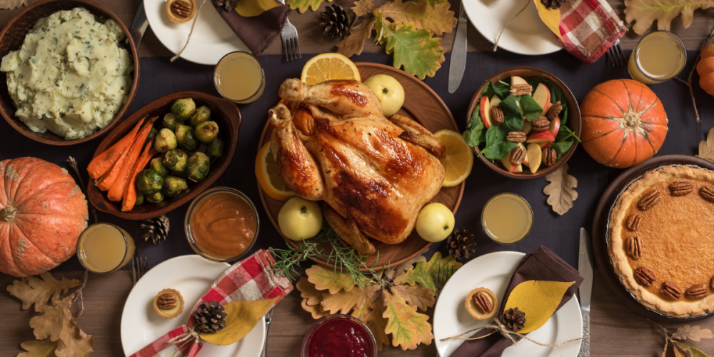 Flat lay shot of a Thanksgiving dinner spread. This article is about what to do with Thanksgiving Leftovers.