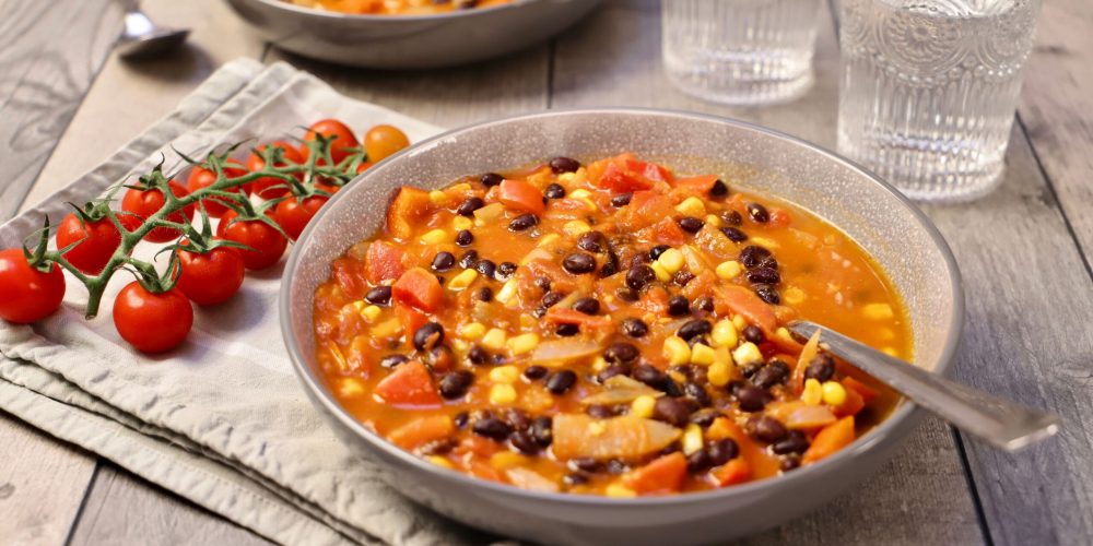 Warm and hearty vegetable bean stew served in rustic bowls, perfect for a cozy meal.