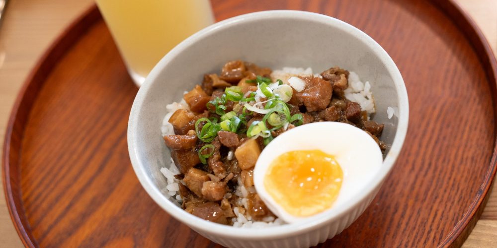 Delicious Taiwanese braised pork rice topped with a soft boiled egg, served in Puli, Taiwan.