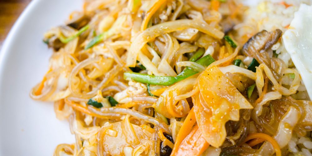 Appetizing stir-fried noodles with vegetables on a plate, perfect for a delicious meal idea.